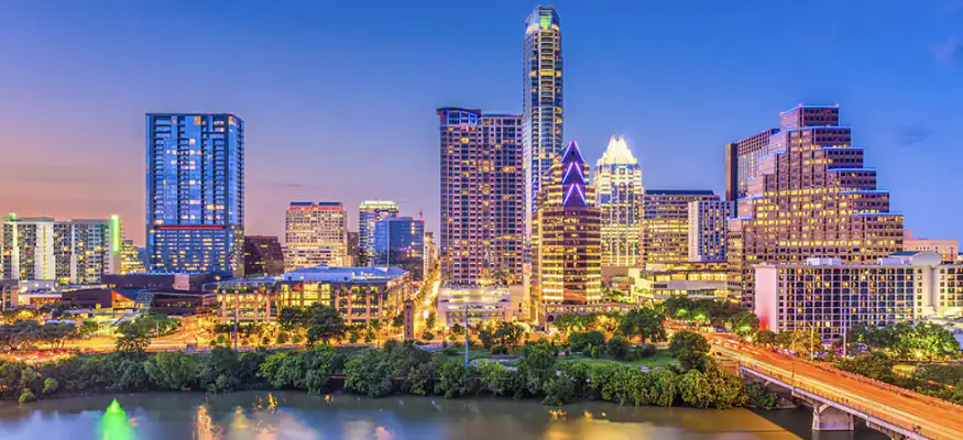 Atlanta skyline at sunset with colorful sky and illuminated buildings